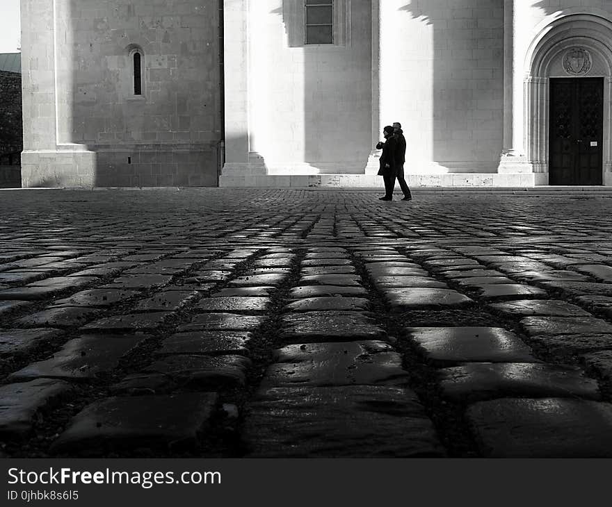 Man and Woman Walking on Empty Street