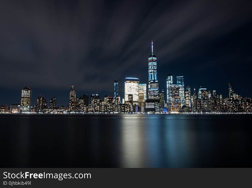 High-rise Buildings at Night Near Sea