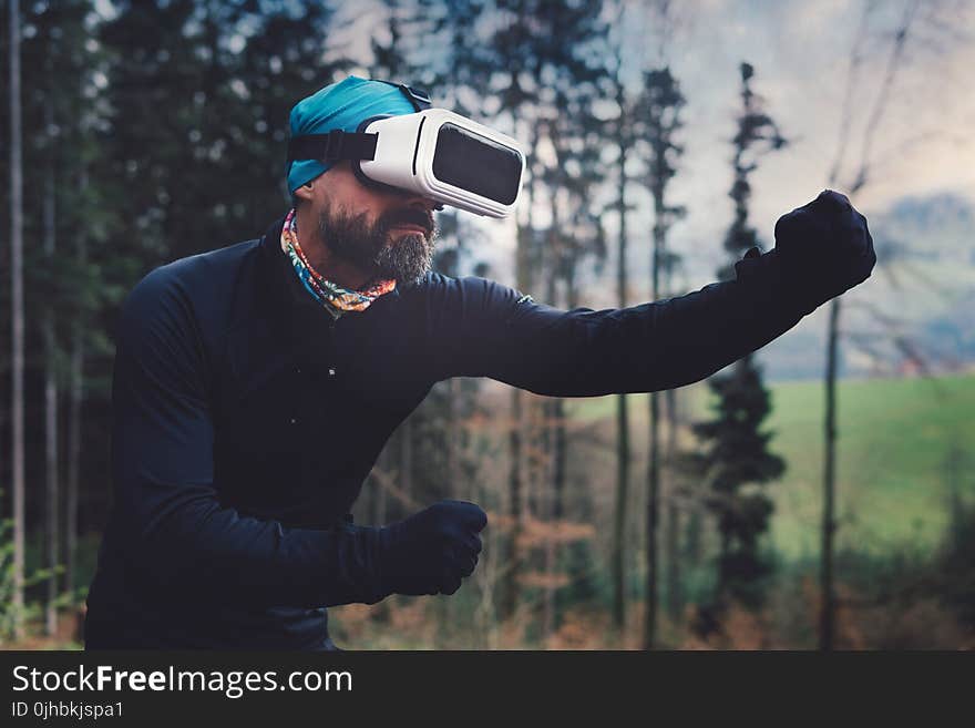 Person Wearing Black Henley Shirt and White Vr Goggles