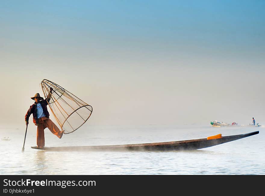 Man Wearing Jacket Riding Canoe