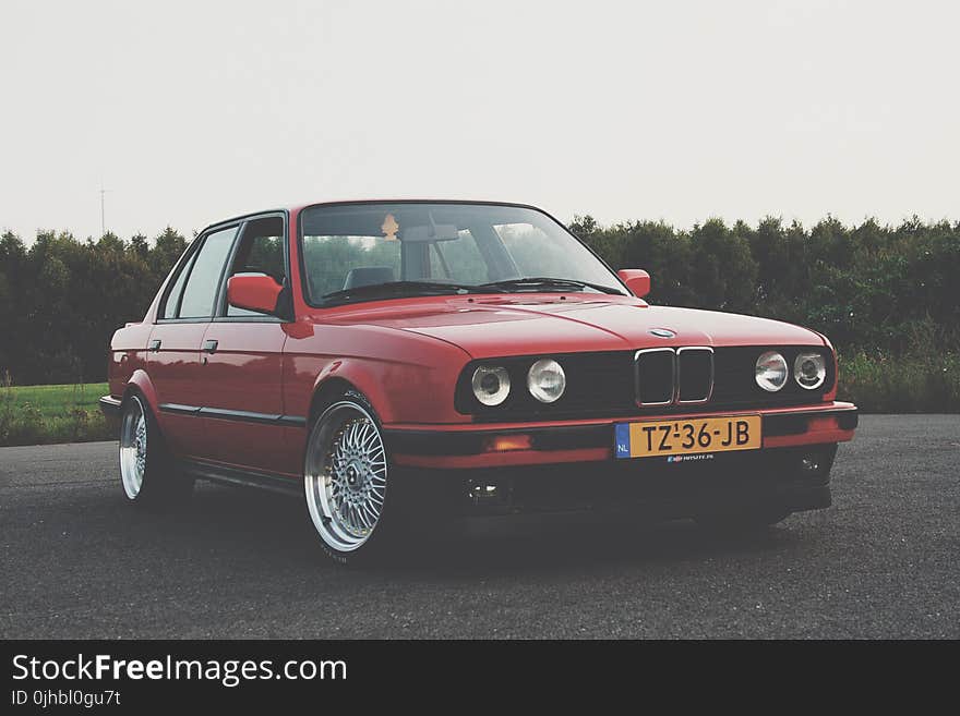 Photography of Red BMW on Asphalt Road