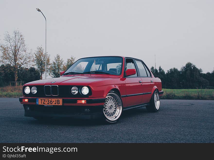 Photography of Red BMW On Asphalt Road