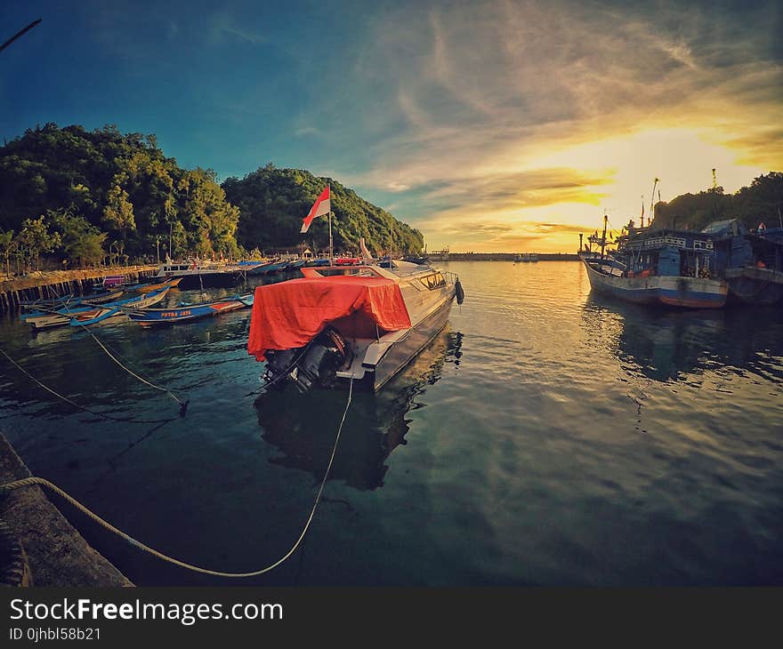 Motor Boat Near Dock during Sunset