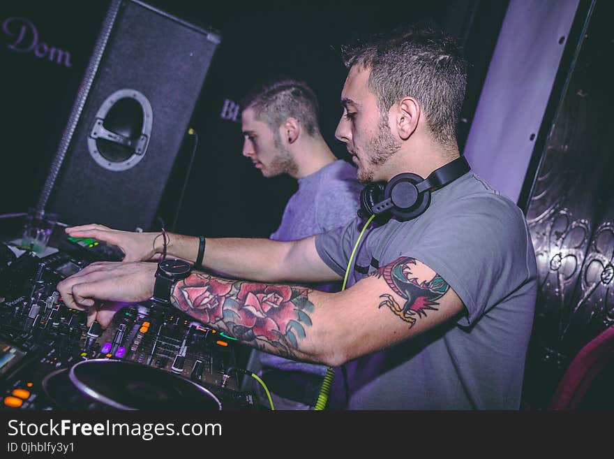 Two Men Standing in Front Dj Mixer