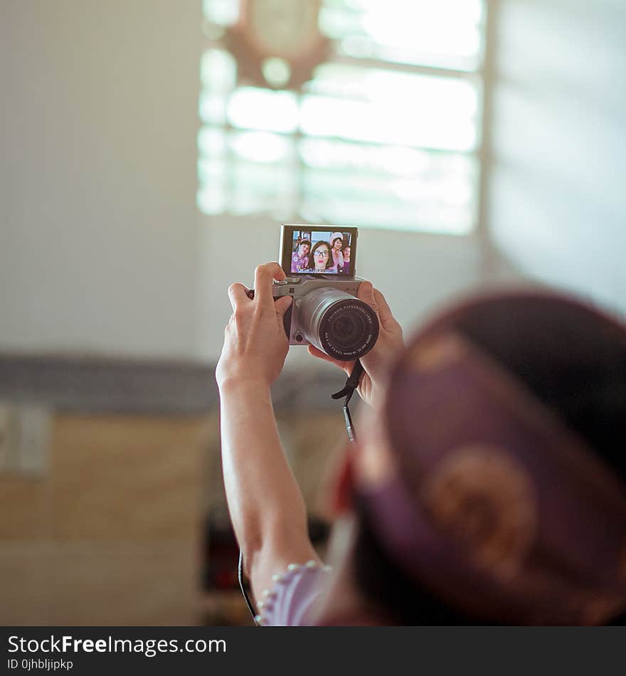 Person Holding Gray Dslr Camera