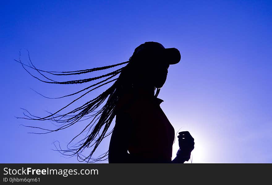 Silhouette of Woman Wearing Cap