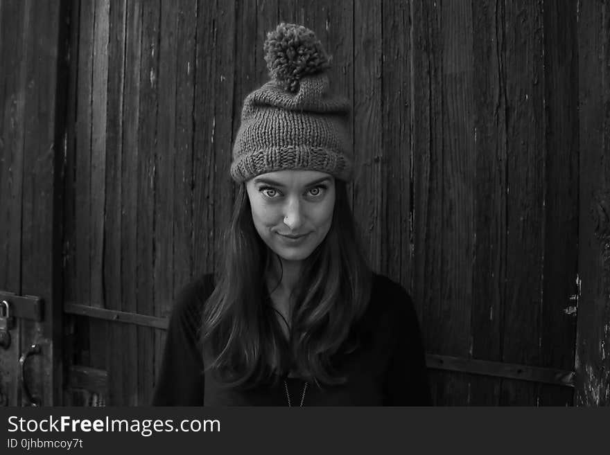 Gray Scale Photo of Woman Smiling in Front of the Camera