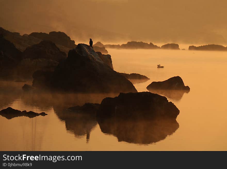 Landscape Photography of Rocky Mountain With Human on Peak of Mountain