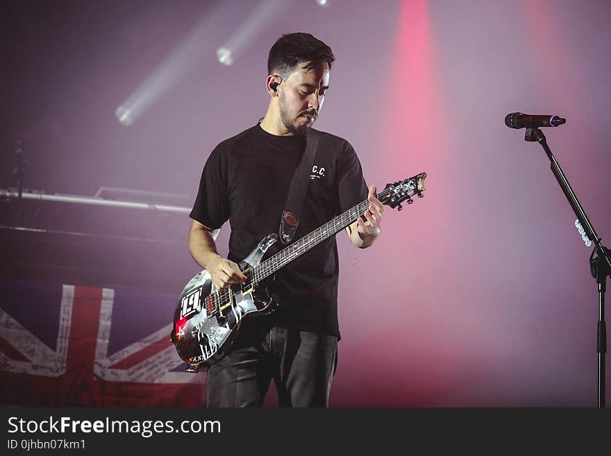 Man Wearing Black T-shirt And Playing Electric Guitar