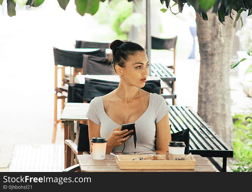 Woman Wearing Grey Shirt Sitting on Chair