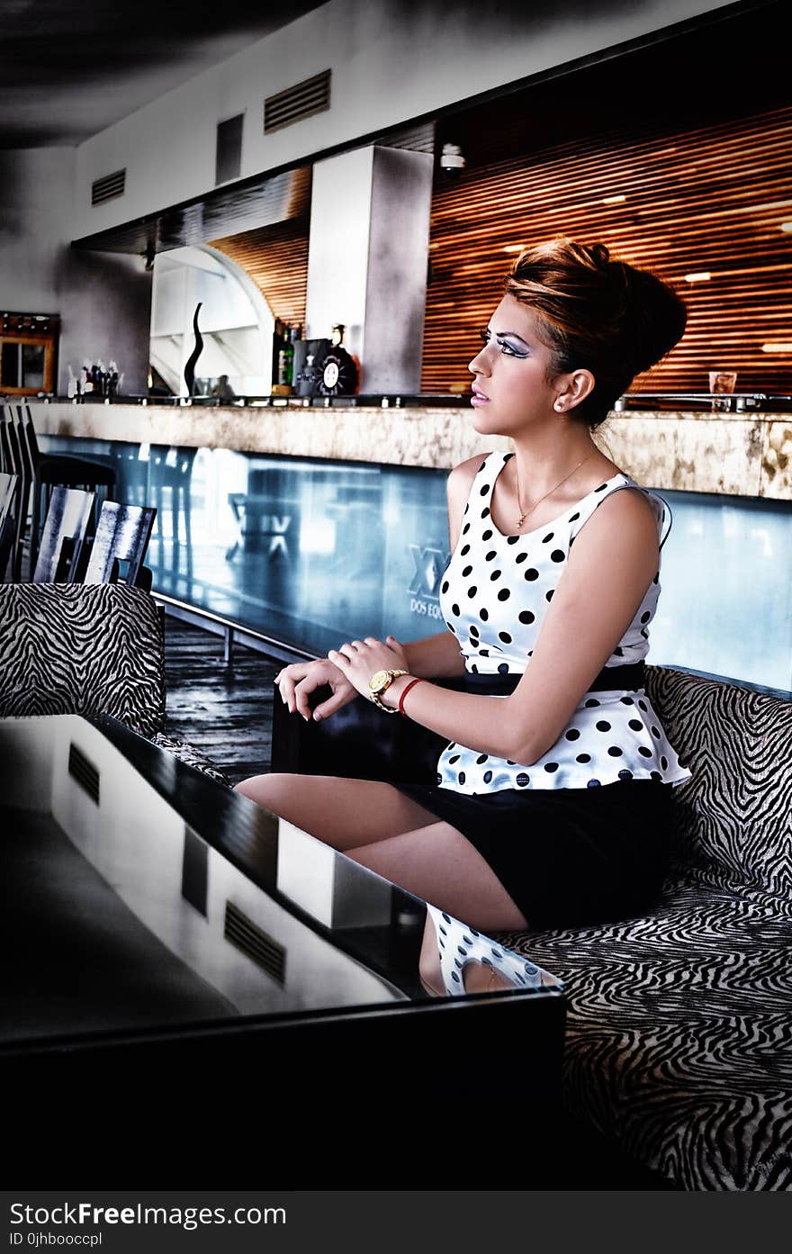 Women in White and Black Dress Sitting on Couch