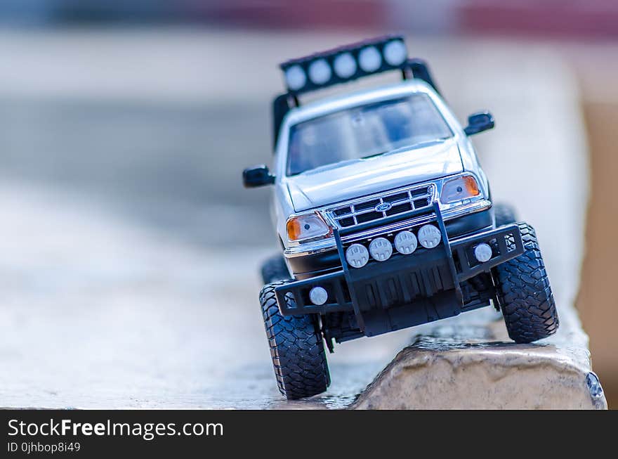 Silver Ford Toy Car on the Ground