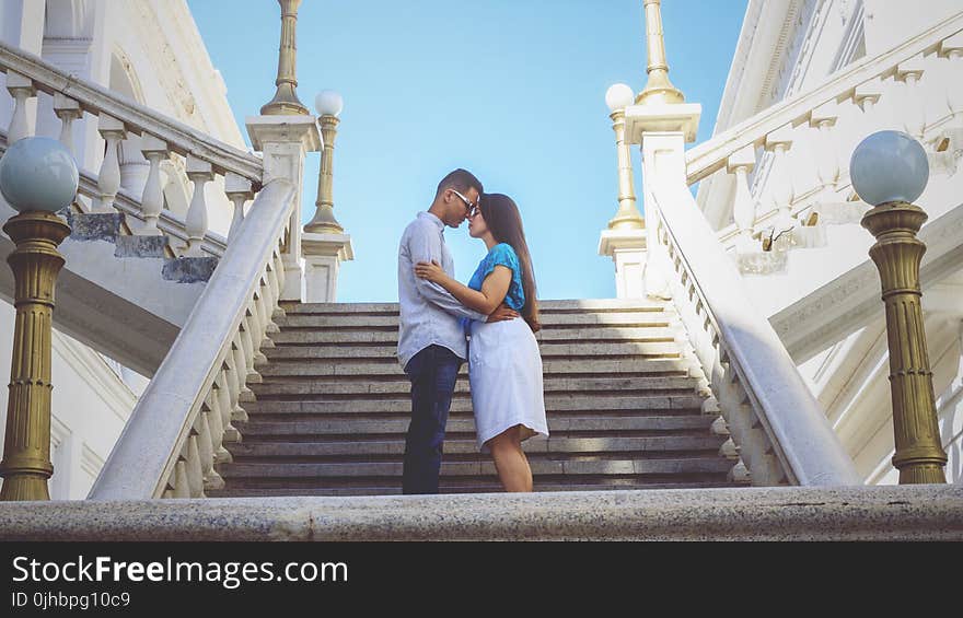 Couple Standing By The Stairs