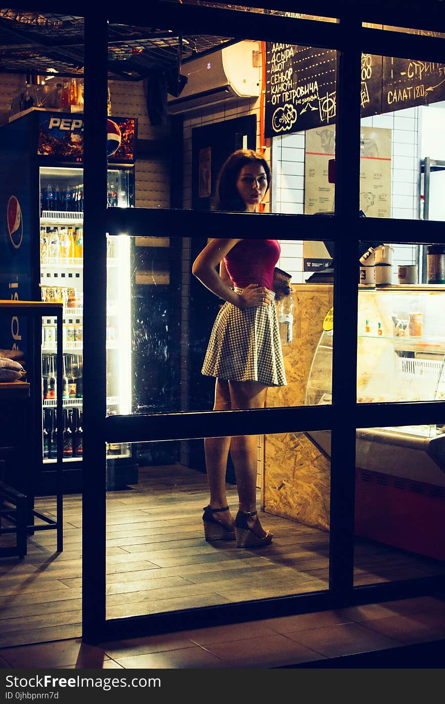 Photo of a Woman Standing in Front of the Counter