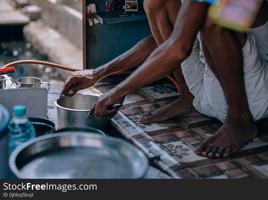 Person In White Shorts Holding Stainless Steel Casserole