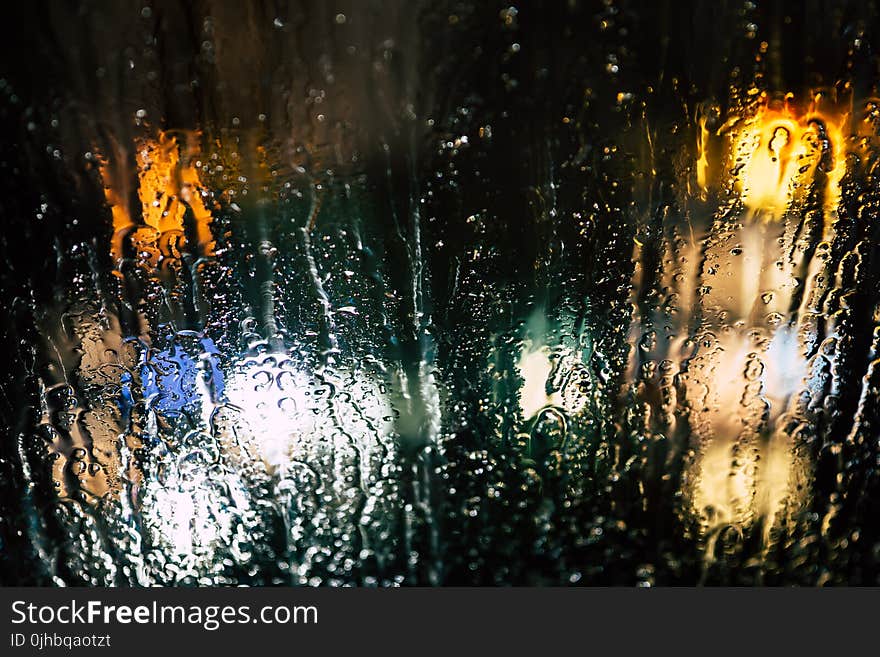 Selective Photography of Glass Window With Drops of Water during Nighttime