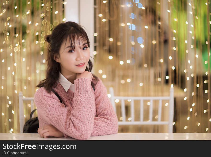 Woman In Pink Sweatshirt Siting On White