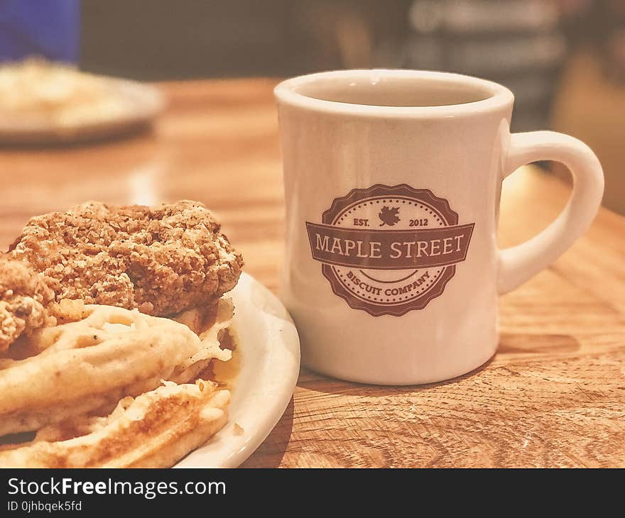 White and Brown Maple Street Ceramic Mug Beside Food