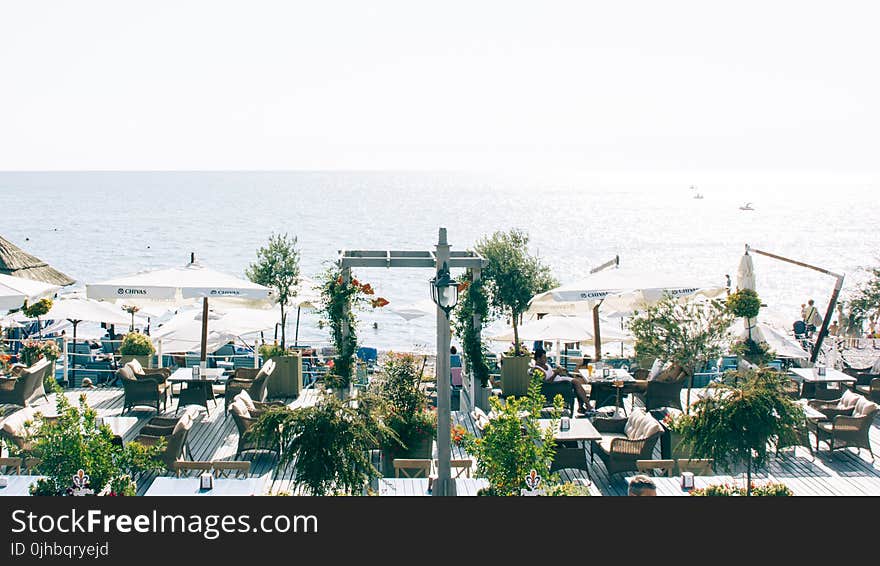 White Patio Table Set Near Ocean