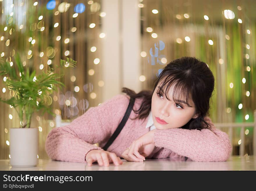 Woman With Her Hands On White Table