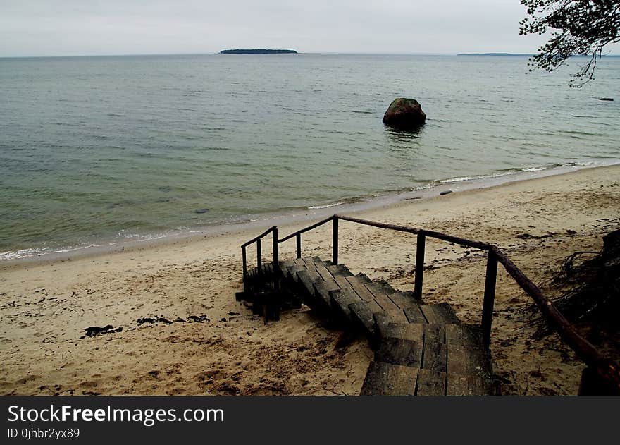 Brown Wooden Stairs Near Body of Water