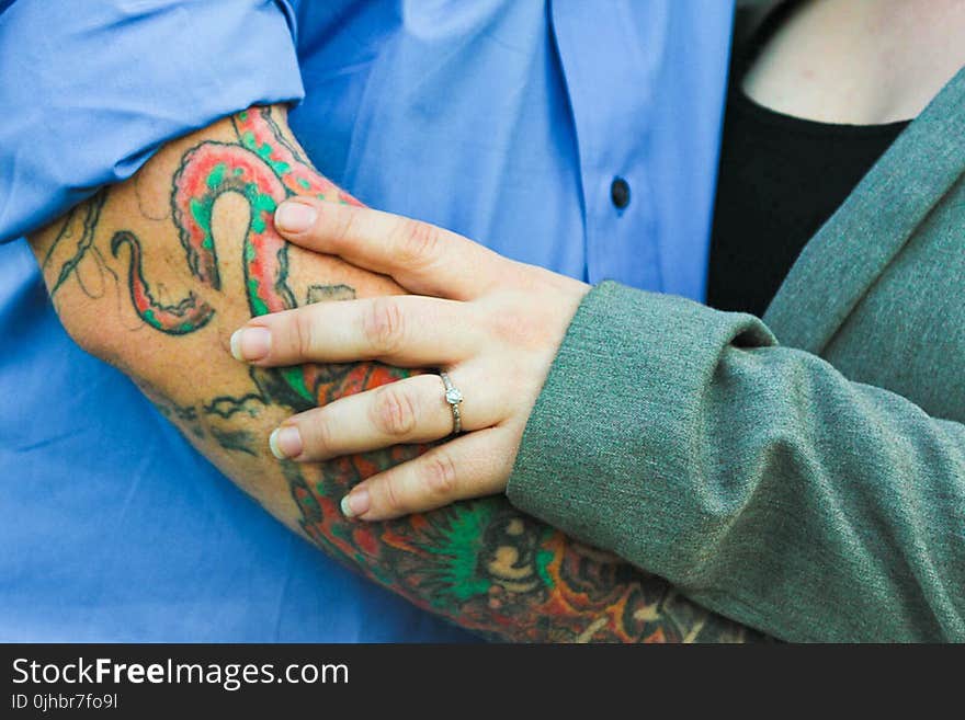 Man With Tattoo With a Woman in Green Top