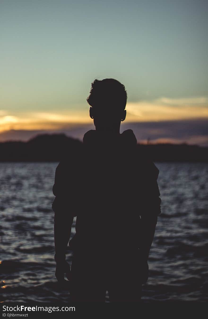 Silhouette Photo of Person Near Body of Water