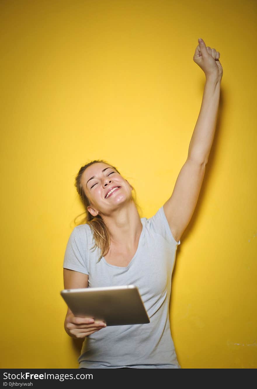 Photo of a Woman Holding an Ipad