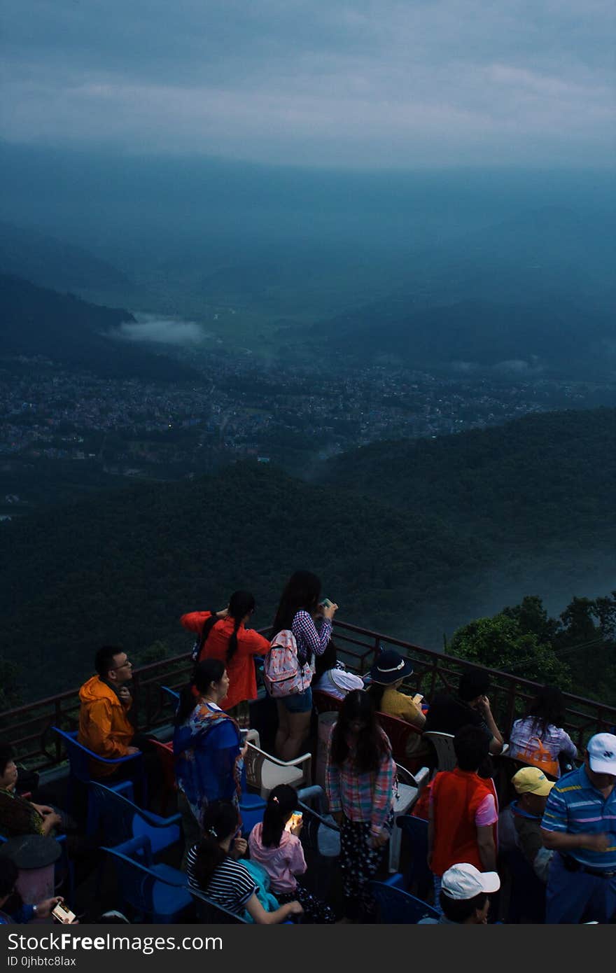 Group of People Looking at Mountain and City View