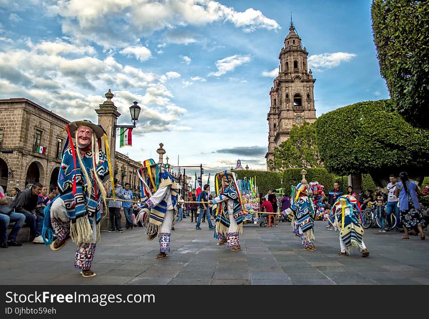 Group of Performers Dancing Near Trees