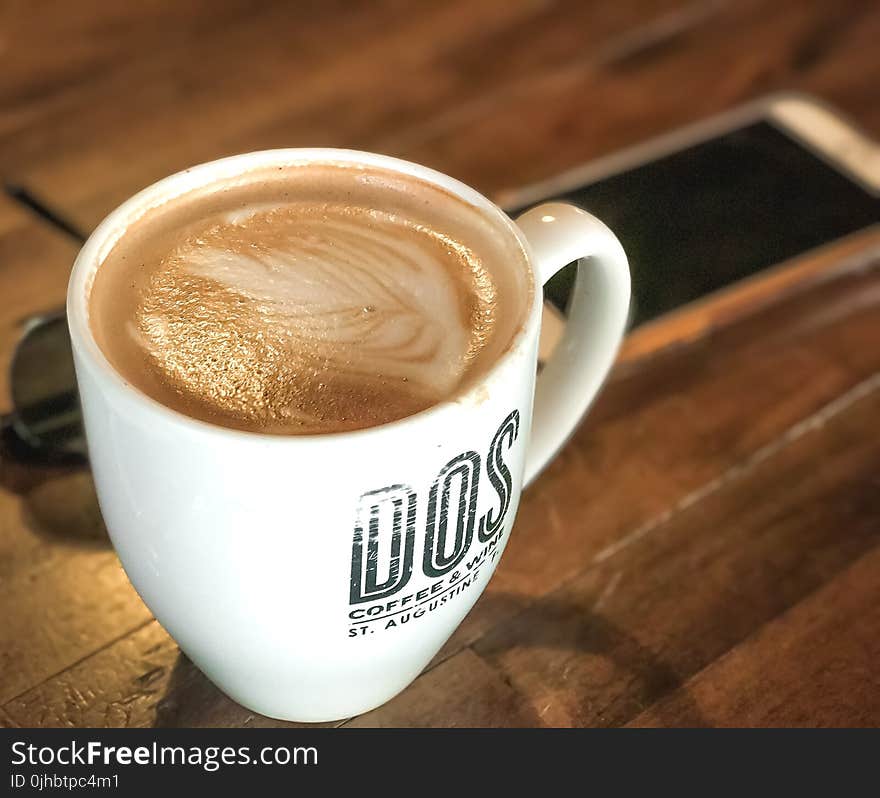 White Ceramic Coffee Mug With Brown Liquid