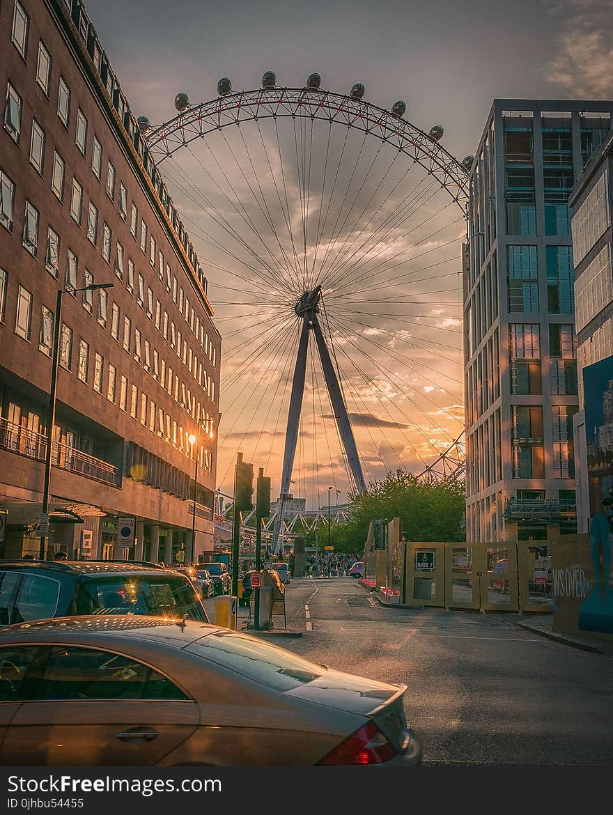 Ferris Wheel Near Building during Sunset