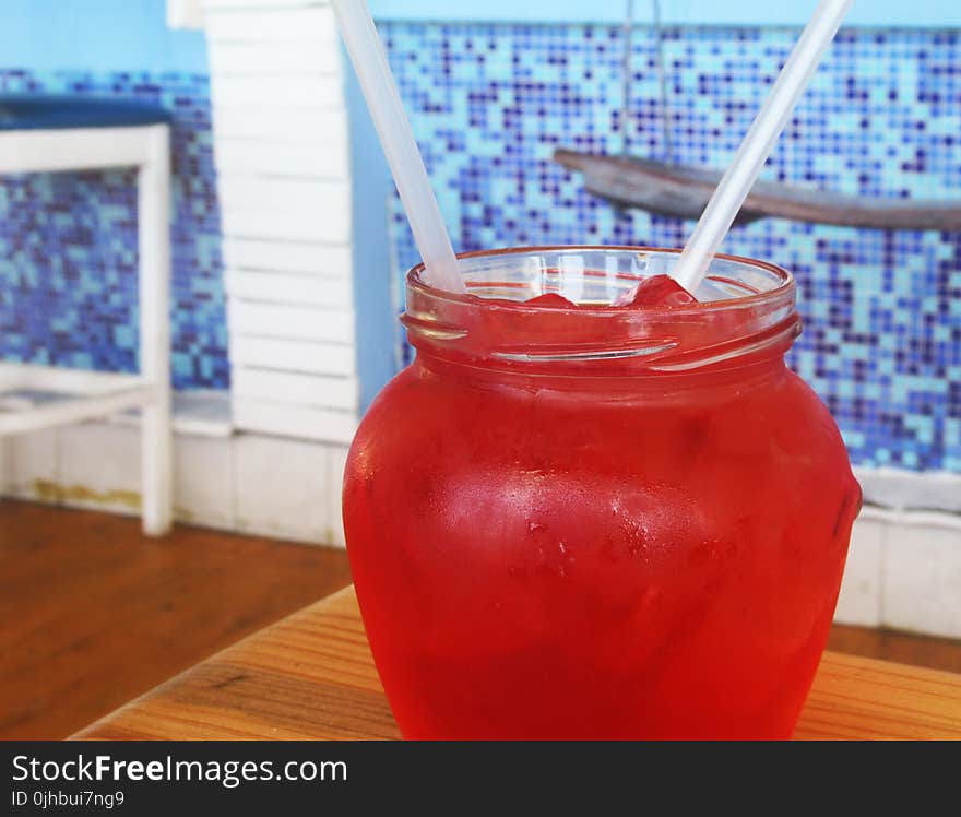 Red Beverage on Clear Glass Dispenser