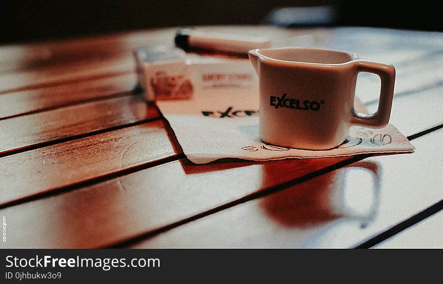 White Ceramic Mug on Table