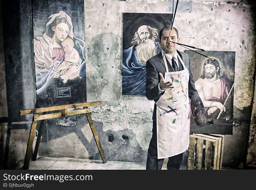 Painter With Apron Beside Portrait Paintings