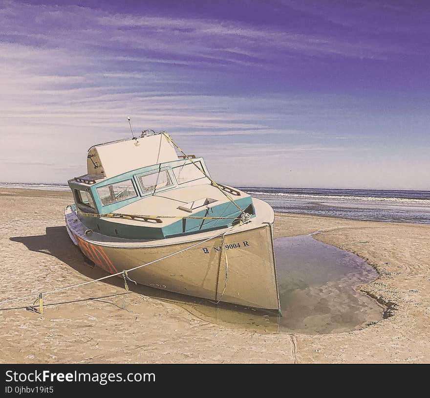 White and Teal Speedboat on Land