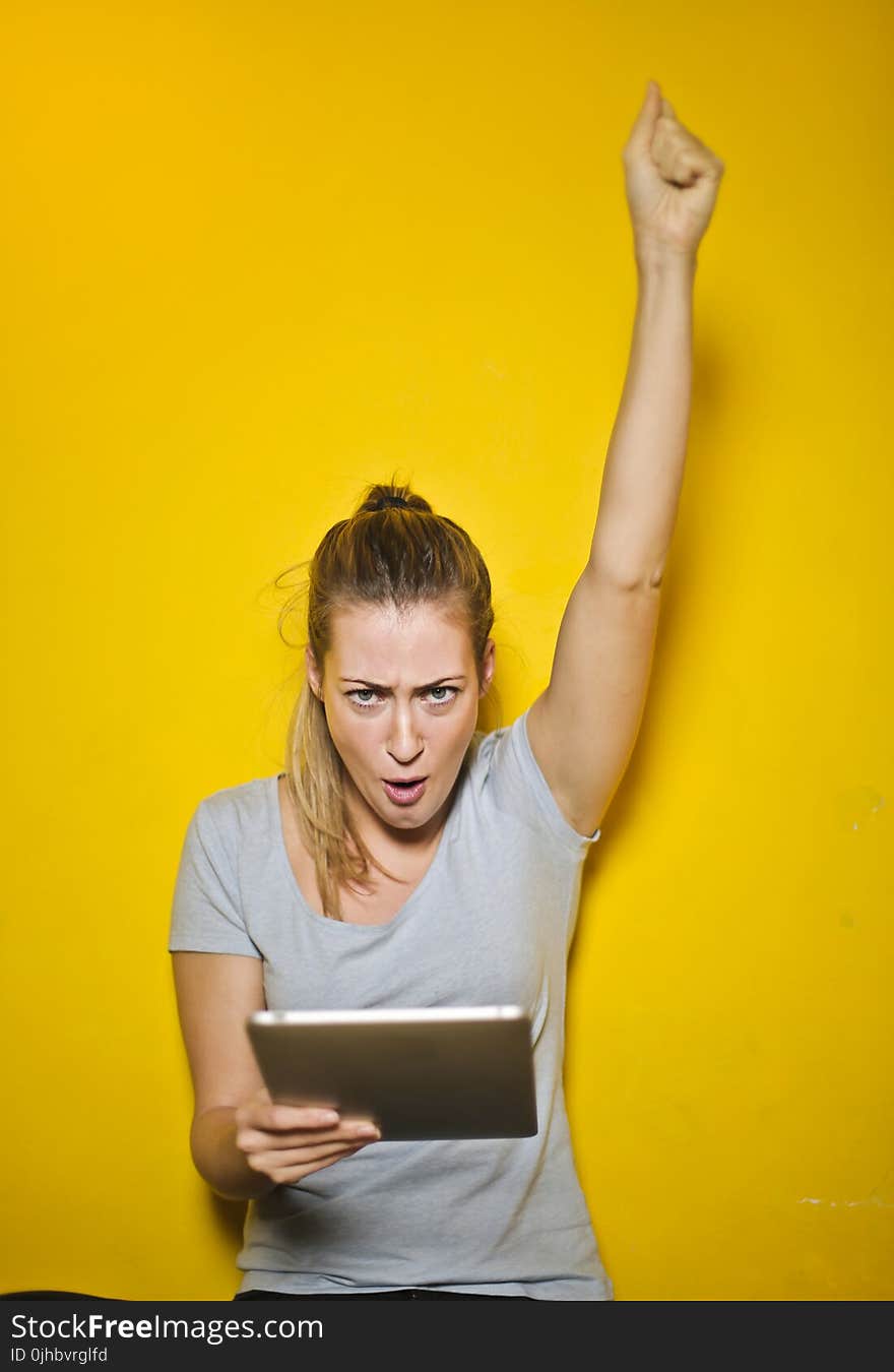 Photo of a Woman Holding an Ipad