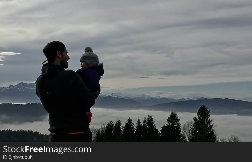 Man Holding a Baby Photo