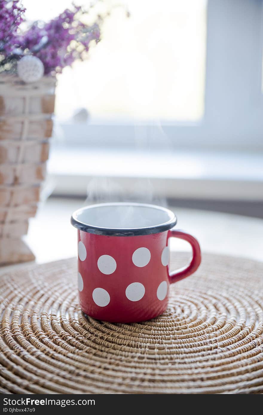 Red, White, and Black Ceramic Mug on Table