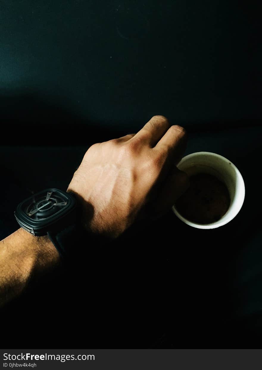 Person Hand and Cup of Coffee