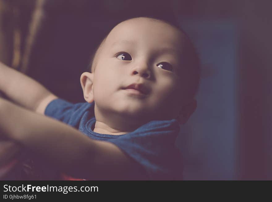 Close-Up Photography of Baby Looking Up