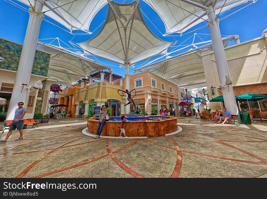 Photo of Woman Sitting Near the Fountain