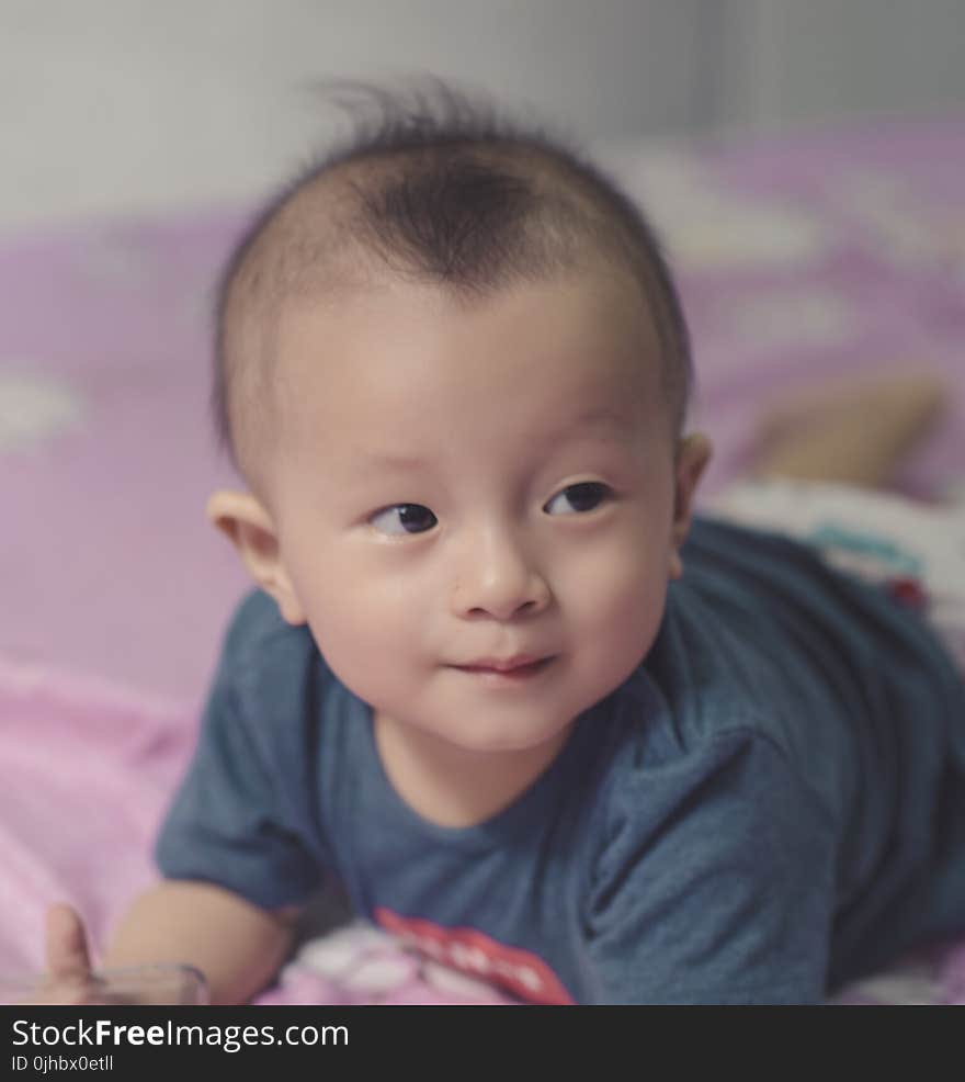 Photography of Cute Baby Laying on the Bed