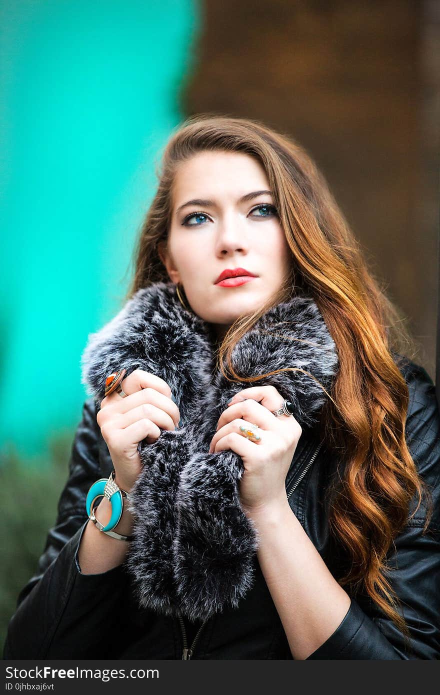 Photo of a Woman Holding Her Black Furry Scarf