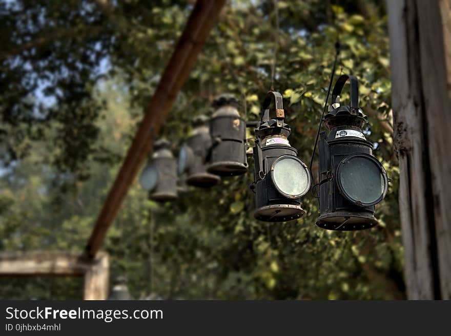 Black Metal Lanterns Hanged in Brown Wooden Frame