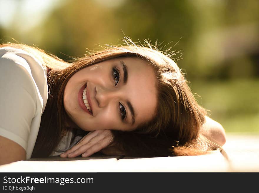 Close Up Photography of Woman Laying on Table