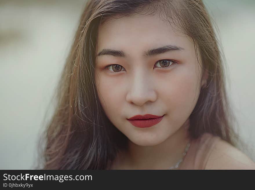 Close-Up Photography of Woman Wearing Red Lipsticks