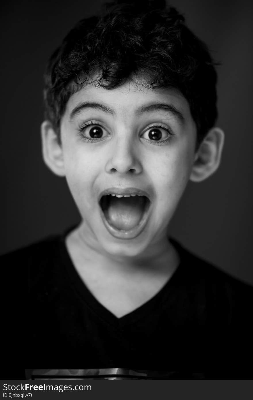 Boy in Black V-neck Shirt With Looking Straight to the Camera With a Shocking Face Expression