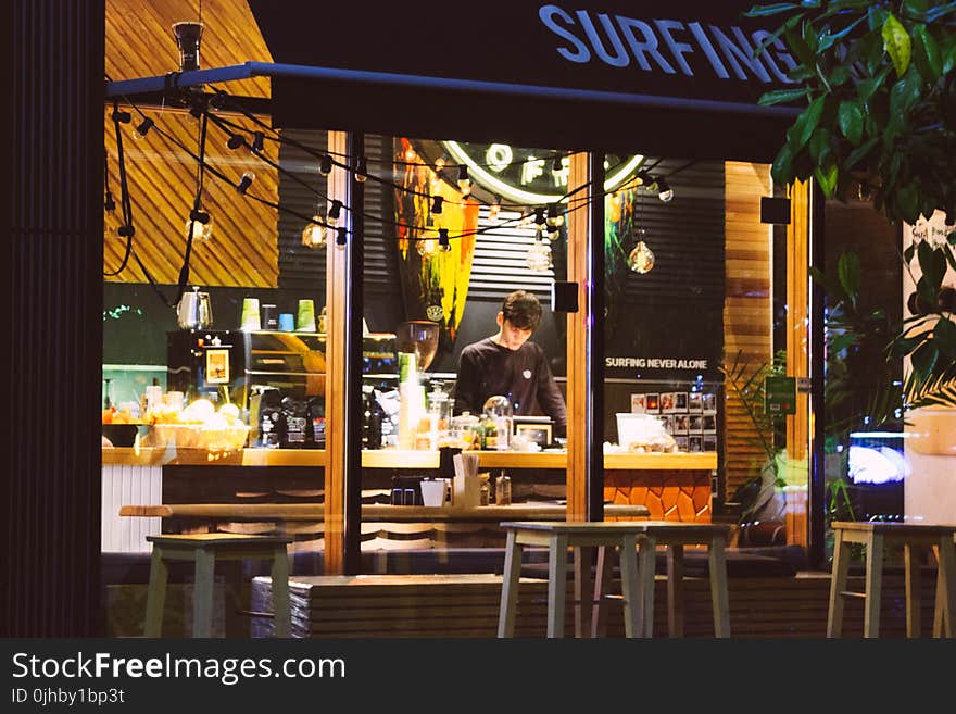 Man Wearing Black Hoodie Standing Near Countertop