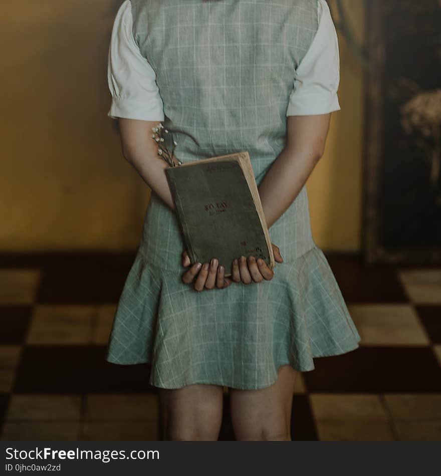 Woman Wearing Grey Dress Holding Book